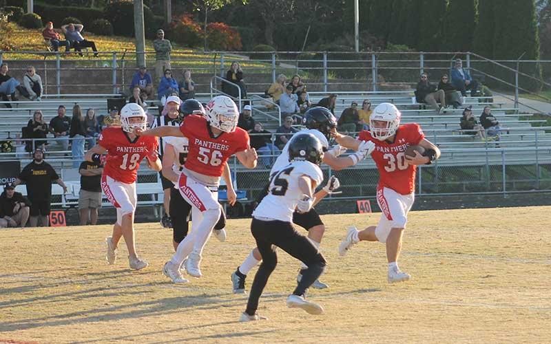 Press photo/Will Woolever - Freshman Swiss army knife Paxton Sutton stiffarms a Tuscola defender at the Panther Pit Oct. 28.