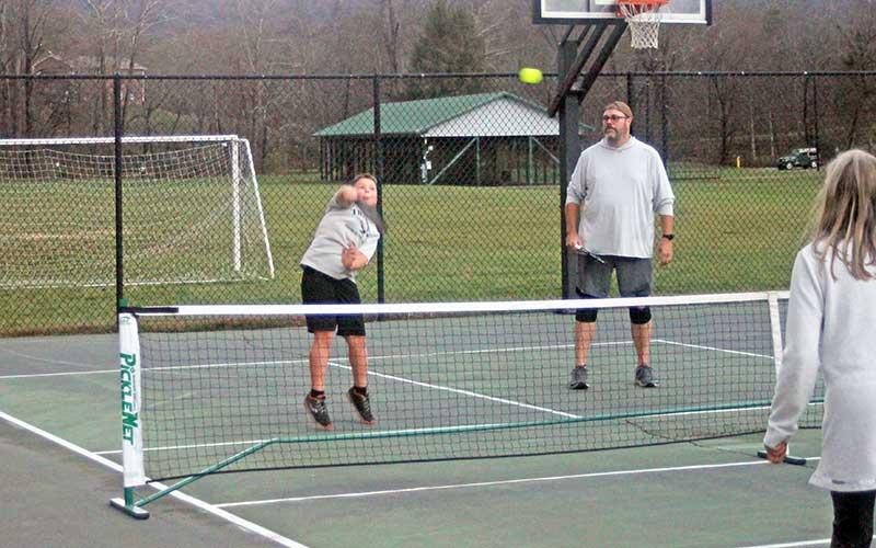 Press photo/Will Woolever - Breck Balmer hits an overhead shot while teammate Gordon Vanderpool looks on.