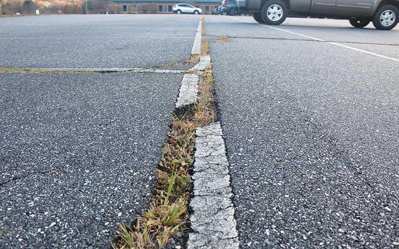 Press photo/Thomas Sherrill - The large cracks in the Mountain View Intermediate main parking lot are a constant trip hazard and a top priority for repaving.