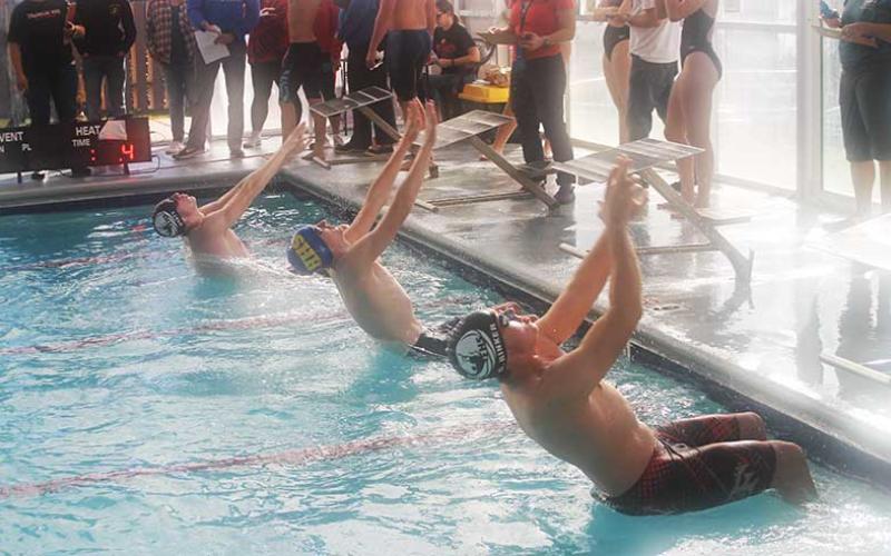 Seniors Jack Hyatt (left) and Gavin Rinker (right) leave their starting blocks in the men’s 100-yard backstroke Nov. 23. (Press photo/Will Woolever)