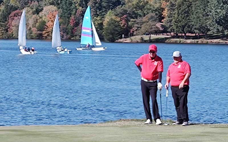 Photo submitted - Golfers Jason Hedrick (left) and Eric Hall line up a putt in a Special Olympics North Carolina Golf Tour event at Oak Hollow Golf Course in High Point last October.
