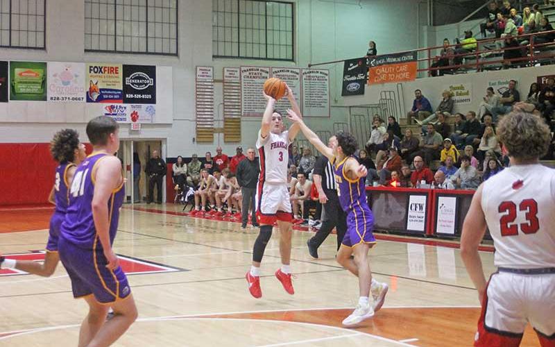 Press photo/Will Woolever - Senior Max McClure attempts a contested 3-pointer versus North Henderson on Tom Raby Court Jan. 7.