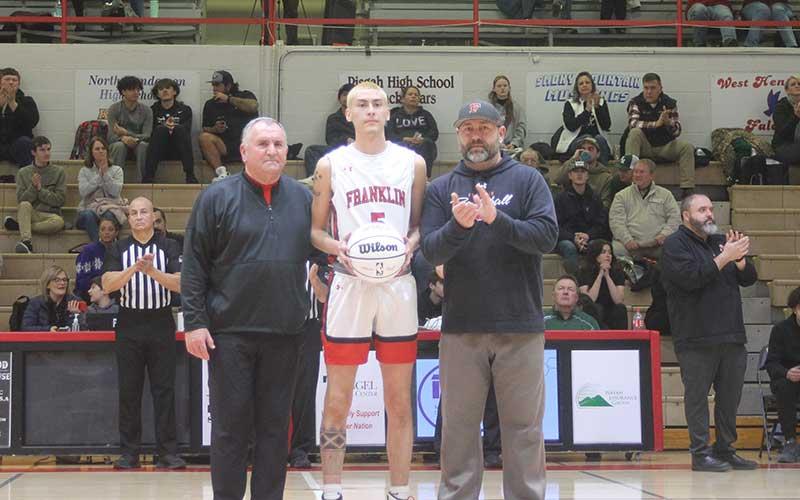 Press photo/Will Woolever - Junior Jack Teesateskie is honored before Franklin’s home game versus East Henderson after recording his 1,000th career point at Hayesville Jan. 16. Teesateskie is pictured with men’s varsity head coach Doug Plemmons (left) and FHS athletic director Matt Bradley.