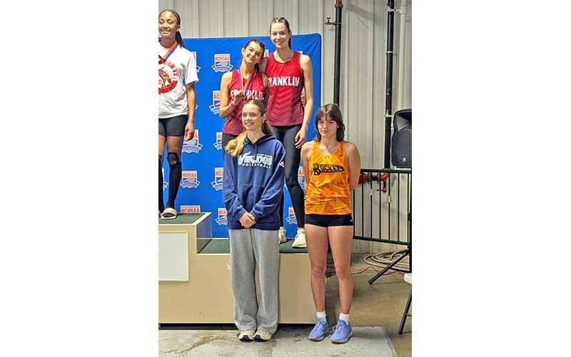 Photo courtesy of Melissa Ward - Justus Bradford (left) and Isabella Shope share a spot on the podium after tying for third in the women’s high jump with leaps of 4’10” at the 3A state meet Feb. 15.