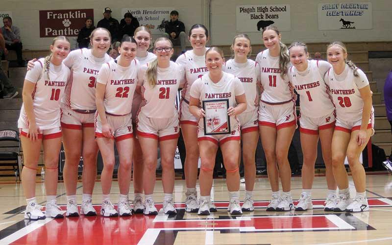Senior guard McKenna Plemmons (holding plaque) is honored for her FHS-record eight 3-pointers at West Henderson Feb. 7, which led her team to a 64-59 win. Plemmons is pictured with her teammates on Tom Raby Court before tipoff of Franklin’s first-round conference tournament win over North Henderson Feb. 14. (Press photo/Will Woolever)