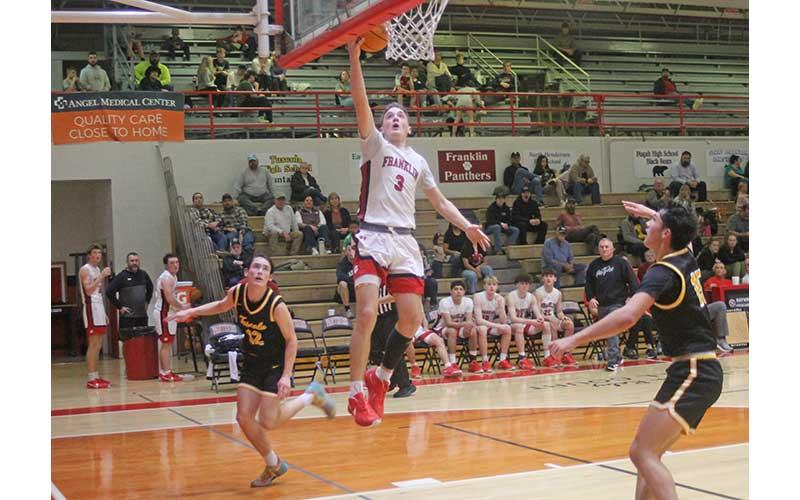 Senior Max McClure sinks an easy layup during Franklin’s first-round conference tournament win over Tuscola Feb. 14.