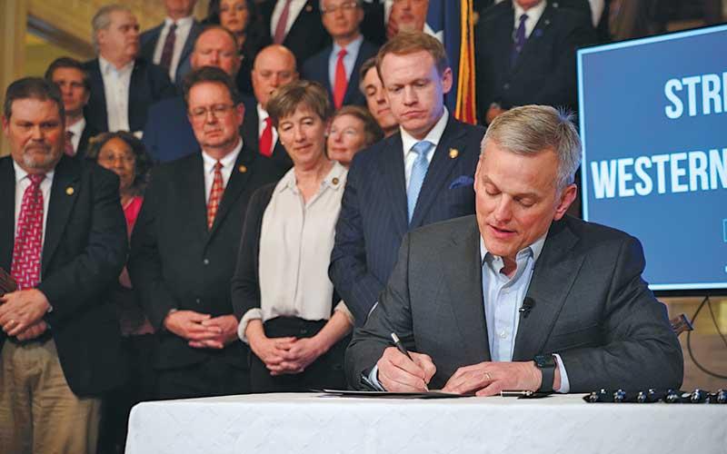 Photo/NC Governor’s Office - Gov. Josh Stein signs the Disaster Recovery Act of 2025 Part 1 on March 19. Looking on are members of the N.C. General Assembly, including Sen. Kevin Corbin (second from left) of Franklin, the WNC Advisory Committee, law enforcement officials and agriculture leaders.