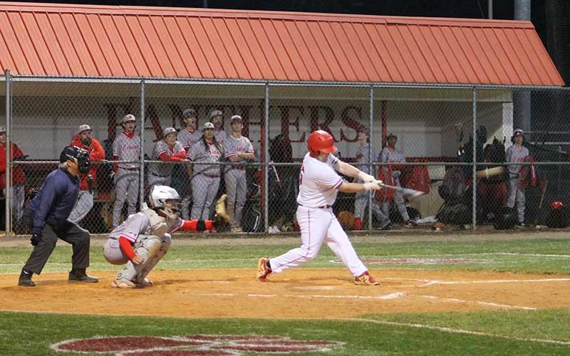 Press photo/Will Woolever - Junior Addix Sutton knocks a third-inning single versus Erwin at McConnell Field March 21. The ball is visible streaking out of frame to Sutton’s right.