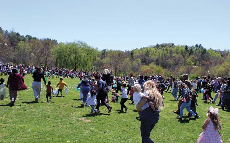 Photo/Shelby Powell - Children and their families rush the field at the fifth annual Easter Egg Drop at South Macon Elementary.