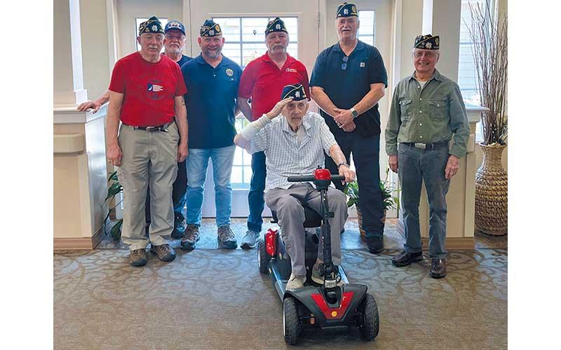 Press photo/Shelby Powell - Representatives and leadership from American Legion Post 108 join Master Sergeant Thomas Kaye (front) after donating him a new motorized scooter. Pictured with Kaye are (from left) Terrence Adams, parliamentarian; Roger Pannabecker of the Sons of the American Legion, Brian Bishop, 1st vice commander; Al Albiston, commander; Kenny Peterson; and Ken Carpenter, past commander.