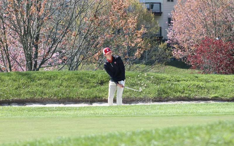 Press photo/Will Woolever - Senior Gabe Stilwell chips out of a bunker on Hole 9 at Sky Valley Country Club April 9.