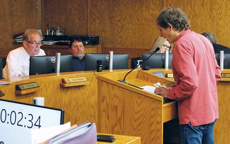 Press photo/Shelby Powell - Local biologist Jason Love (right) discusses unnecessary damage to local waterways caused by U.S. Army Corps of Engineers debris removal efforts. Listening are County Commissioners Gary Shields and John Shearl.