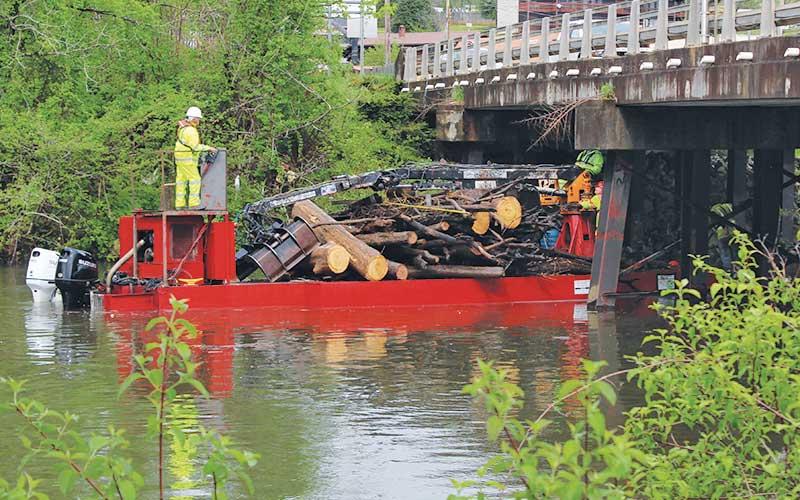 Press photo/Shelby Powell - Contractors for the U.S. Army Corps of Engineers remove debris along the section of the Little Tennessee River in East Franklin.