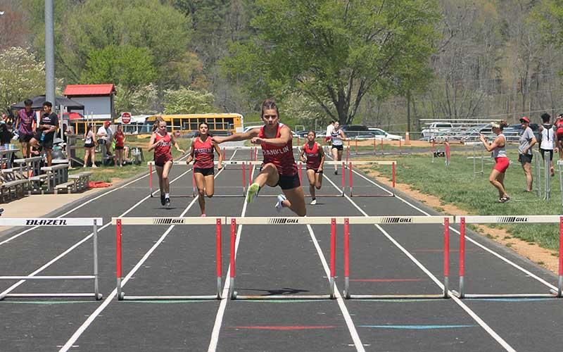 Press file photo - Laura Covarrubias wins the 300-meter hurdles at Franklin’s first home meet since 2019 last month. Also pictured from left are teammates Jenna Holden, Justus Bradford and Kai Pelletier.
