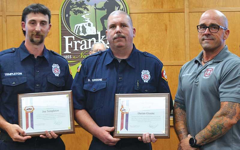 Press photo/Mia Overton - Franklin firefighters Joe Templeton and Darian Greene were presented Life Saving Awards for their actions to rescue a man from a burning structure on May 8. Chief Ben Ormond presented the awards at the June 2 Franklin Town Council meeting.