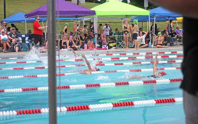 Press photo/Will Woolever - FAST swimmers ages 11-12 compete in the 200-yard medley relay June 12 at the Macon County Rec Park. From left are Naomi Green, Wylie Hinton and Larken Lynch.