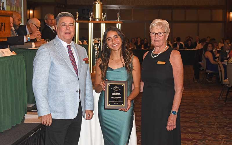 Senior Laura Covarrubias shows off her Division I Female Academic Award along with the Mountain Amateur Athletic Club’s Jan Stanley.