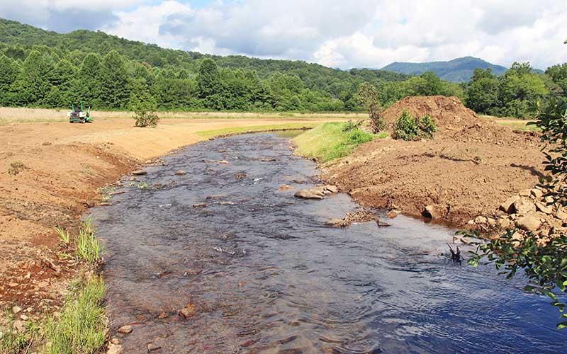 Press photo/Shelby Powell - Contractors are continuing to work on rebuilding and enhancing the riverbank along Jones Creek, next to Maiden’s Chapel.