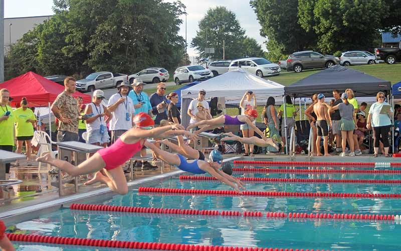 Press photo/Will Woolever - Swimmers leave their starting blocks for the girls 8 &amp; under 100-yard individual medley July 3.
