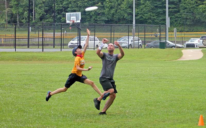 Press photo/Will Woolever - Appalachian Ultimate Frisbee Club members Elijah Moore (left) and Chris McConnell track a frisbee into the end zone at Parker Meadows July 13.