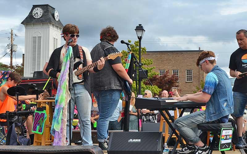 Press photo/Mia Overton - Low Tide brought the sounds of the 80s to life during the parade on Saturday, Aug. 2 as part of 80s Flashback Weekend festivities. The band performed Prince’s “Purple Rain” as they stopped for the judging at the intersection of Main and Iotla Streets. See more photos on The Franklin Press Facebook page.