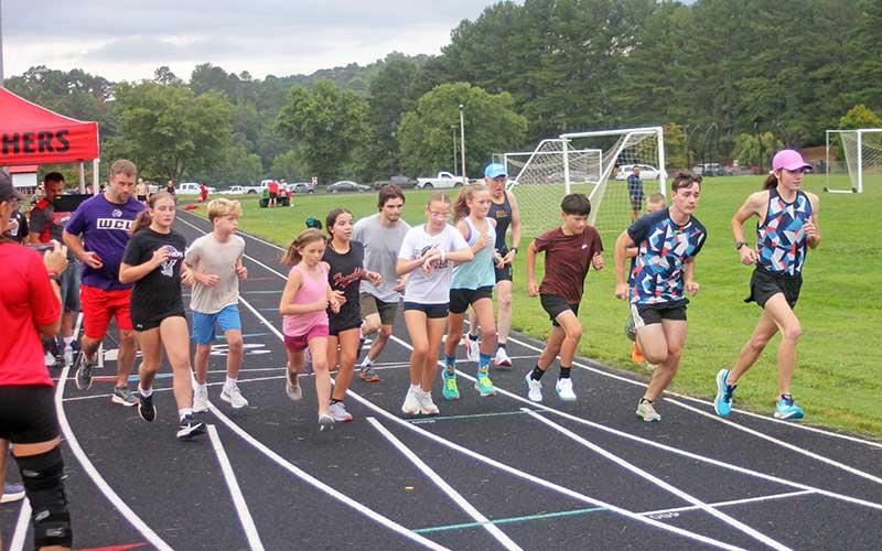 Press photo/Will Woolever Panther cross country fans and future/former runners leave the starting line for an Open Heat before the varsity race.