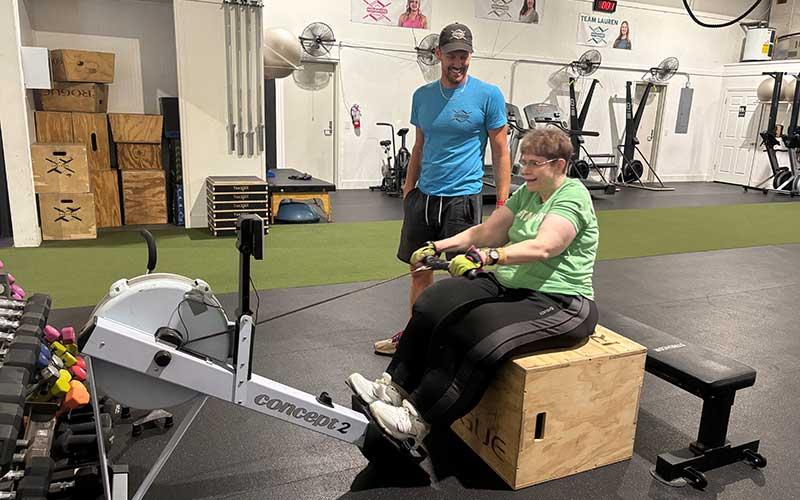 (Press photo/Will Woolever) Gale Helix uses the rowing machine at MoveMore Fitness recently during a private session with gym owner Matt Harlfinger.