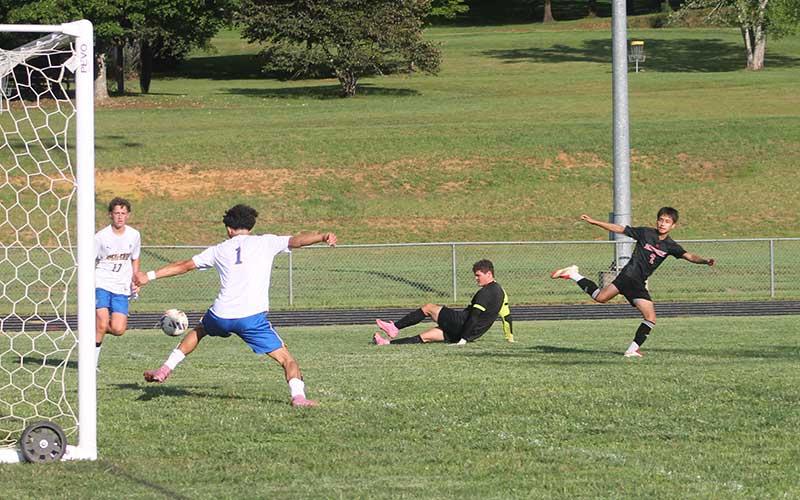 Press photo/Will Woolever - Sophomore Arturo Soto (right) watches his shot sail into the net in Franklin’s home opener versus Highlands Aug. 14.