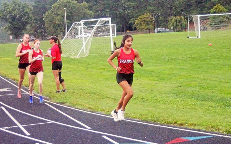 Press file photo - (From left) Abigail Pope, Mindi Holbrooks and Amy Mendoza Lopez are pictured in Franklin’s season-opening meet at Macon Middle School Aug. 13.