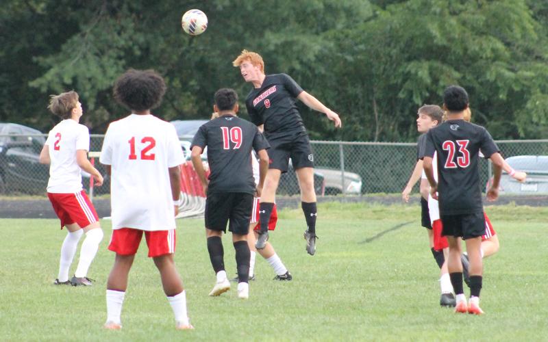 Press photo/Will Woolever.  Junior center back Malik Walker heads a ball away from danger versus Hendersonville at Macon Middle School Aug. 27.