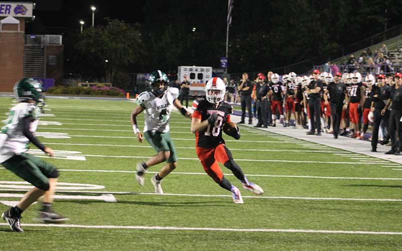 Press photo/Will Woolever - Senior Payton King eyes the end zone on an 18-yard touchdown reception in Franklin’s 59-0 rout of East Henderson Sept. 11.