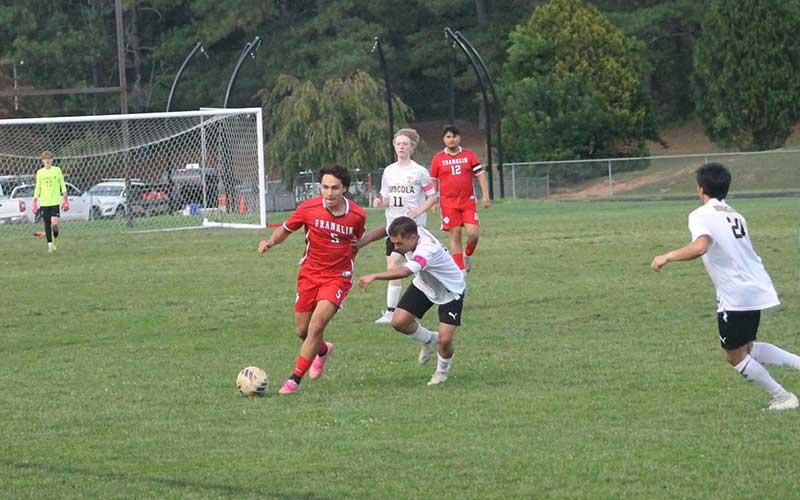 Press photo/Will Woolever - Junior Kevin Torres (left) evades a Tuscola defender during his hat trick (three-goal) match at Macon Middle School Sept. 22.