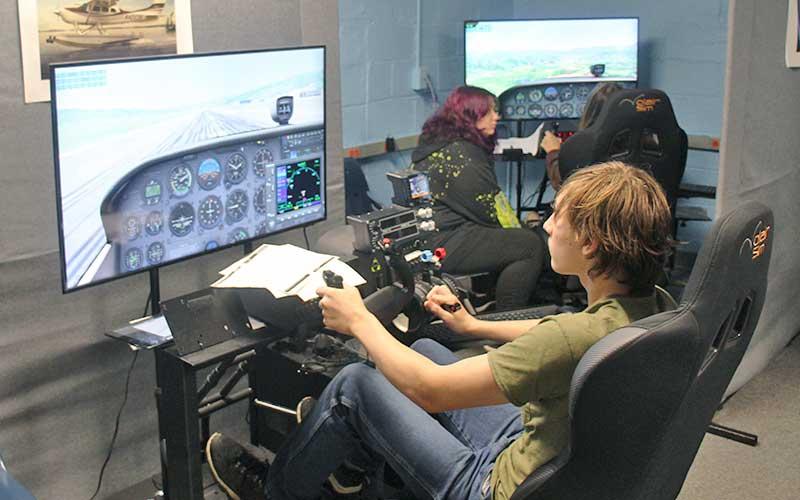 Press photo/Shelby Powell - Franklin High School students enrolled in the aviation program use flight simulators housed in the old terminal building at the Macon County Airport.