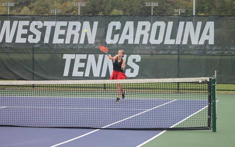 Freshman Eva Holland hits a difficult overhead shot in the 5A West Pre-Regional Tournament at Western Carolina University Oct. 6. (Press photo/Will Woolever)
