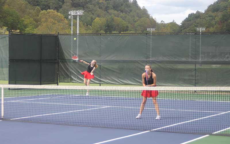Press photo/Will Woolever Clara Stork serves while Marlee Barnes guards the net in the 5A West Pre-Regional Oct. 7.