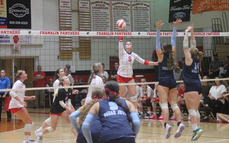 (Press photo/Will Woolever) Senior Carrie Holland lifts a ball over the net in Franklin’s second-round state playoff game versus Enka on Tom Raby Court.