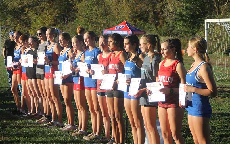 Press photo/Will Woolever - Abigail Timan (left), Amy Mendoza Lopez (second from left) and Morgan Cress (right) show off their All-Conference plaques after finishing among the top 14 girls in the Mountain Eight Championship meet in Hendersonville Oct. 14.