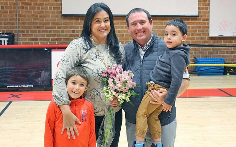 Press photo/Shelby Powell - Nishelle Henson received the Regional Teacher of the Year award for Western North Carolina. Joining her at a surprise celebration last week in the Macon Middle School gym are her husband Jon and sons Noah and Jacob.