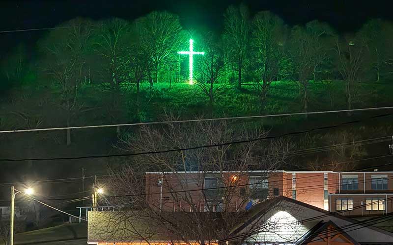 Press photo/Mia Overton - For 40 years the Sanders family has shared the Christmas spirit by lighting a cross on the hill overlooking East Franklin.