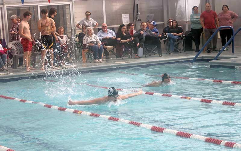 Press photo/Will Woolever - Thatcher Daniels swims a close race in the boys 100-yard butterfly at a FHS/MEC home meet Dec. 6