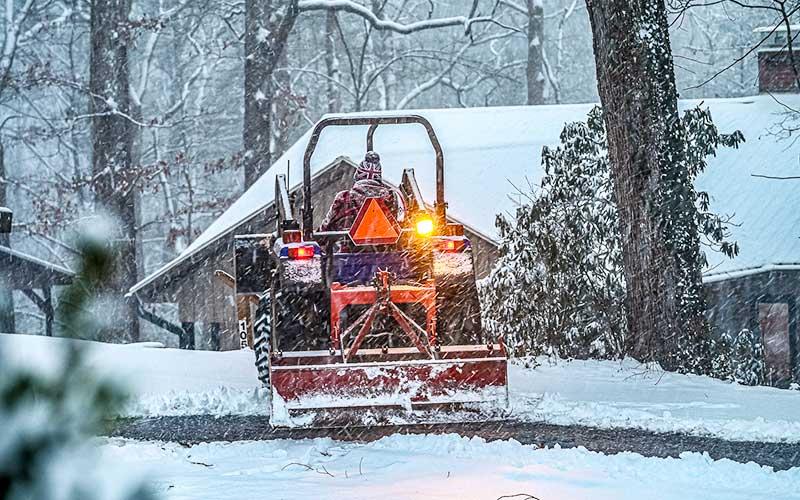 Photo/Bob Scott - John Bueck scraping Summit Drive in Franklin.