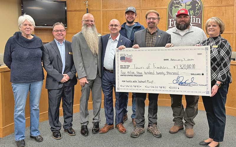 Press photo/Mia Overton - The Town of Franklin has received $4.3 million in federal funding for work at the water treatment plant. Pictured at the Feb. 7 check presentation are Town Council members Rita Salain, Travis Higdon, Jeff Berry, Mayor Stacy Guffey, Water Treatment Plant Supervisor Kyle Pocquette, Congressman Chuck Edwards, Public Works Director Bill Deal and Town Manager Amie Owens.