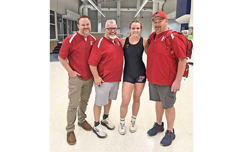 Photo submitted - Senior Carrie Holland is pictured with Panther coaches (from left) Joel Schick, Jimmy Barnett and Matt Bailey after the 5A West Women’s Regional at Parkwood High School last week.