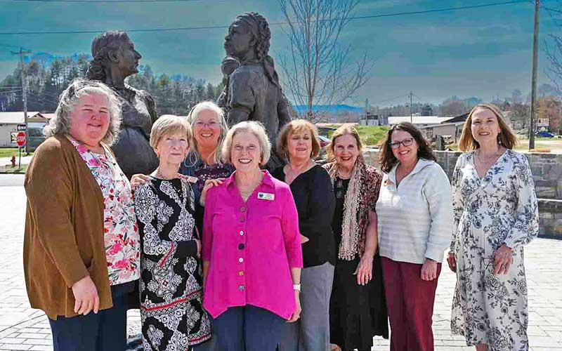 Photo/Bob Scott - Nancy Siler Scott (second from left) was honored as the 2026 Macon Matriarch. The award is presented by the Folk Heritage Association of Macon County. Scott is pictured at the Sowing the Seeds of the Future sculpture with FHAMC board members Claire Suminski, Theresa Ramsey, Janet Greene, Anne Hyder, Marty Greeble, Mia Overton and Mary Polanski. Susan Ervin, not pictured, also served on the selection committee.