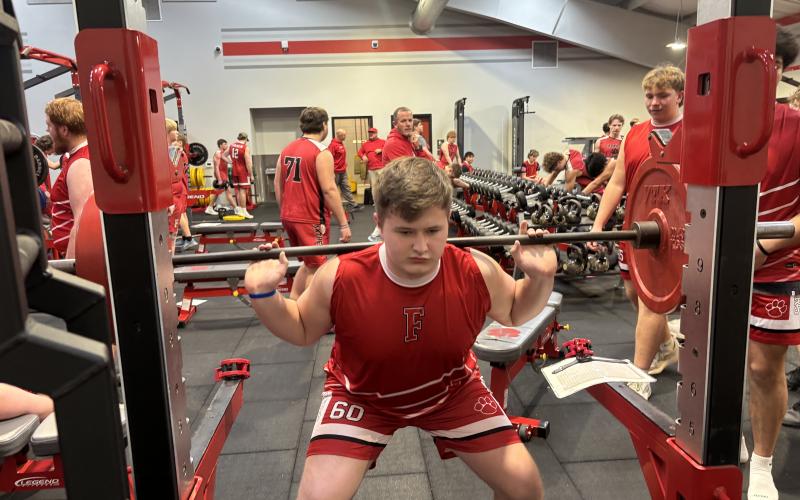 Press photo/Will Woolever.  Wesley Maxson performs a barbell back squat during a Bigger, Faster, Stronger physical education class at Macon Middle School recently.