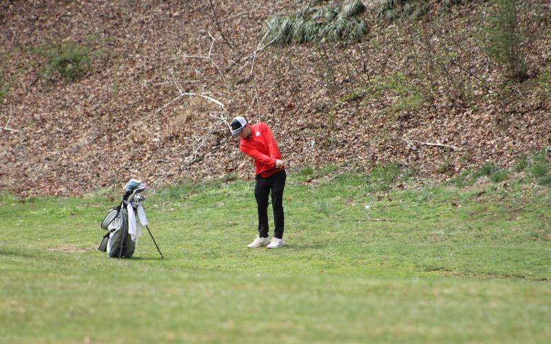 Press photo/Will Woolever. Braylen Dulicai chips from the first fairway at the Franklin Golf Course March 18. The ball is visible in the lower right.