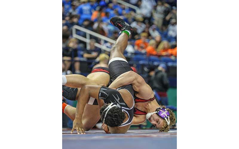 Photo courtesy of Josh Young - Garrett Young takes down a wrestler from Havelock in the 5A State Quarterfinals in Greensboro last month.