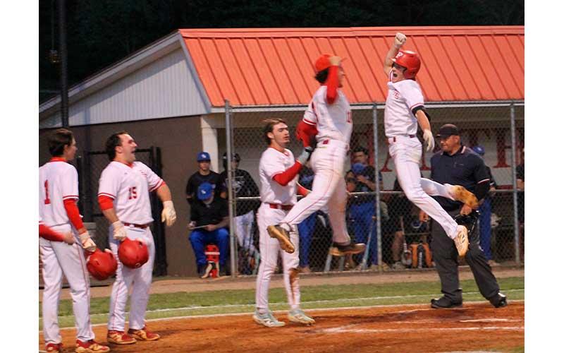 Anderson Terrell (right) celebrates with teammates at home plate after his grand slam versus Smoky Mountain April 21. (Press photo/Will Woolever)