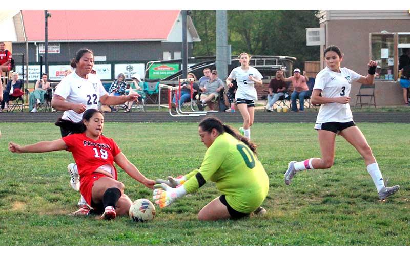 Lilly Tux races East Henderson's keeper to a loose ball at Macon Middle School April 15. (Press photo/Will Woolever)