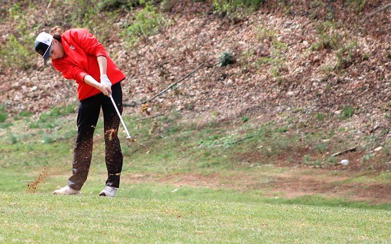 Peyton Hurst chips off the first fairway at the Franklin Golf Course March 18. The ball is visible in the lower right. (Press file photo)